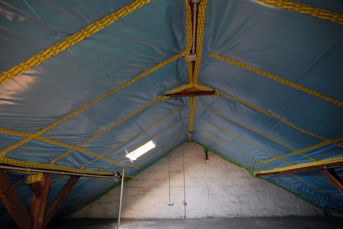 Zolder van binnenuit: dampremmende folie onder de sporen, met alle naden en aansluitingen afgeplakt met tape